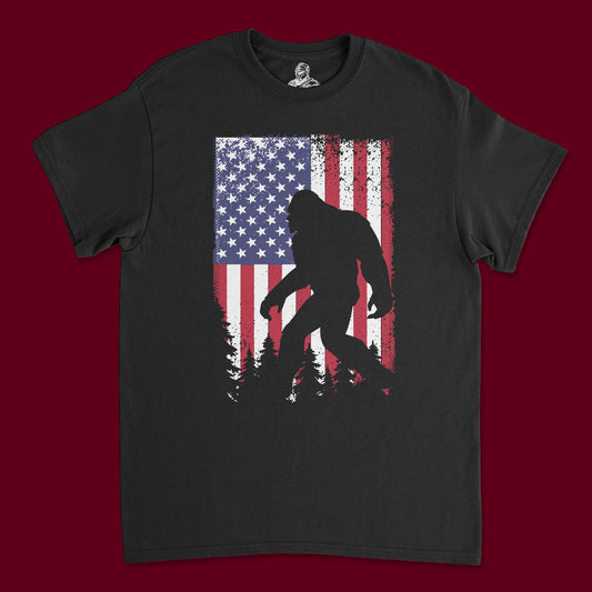 Short Sleeve T Shirt - Big Foot Strolling with American Flag in Background